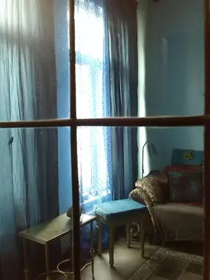 a room with a window with a couch and a table at Artistic appartment near downtown & railwaystation in Antwerp
