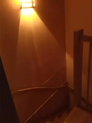 a bathroom with a light on the wall at Artistic appartment near downtown & railwaystation in Antwerp