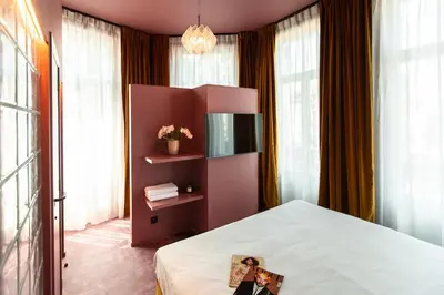 a bedroom with a bed with a picture on it at The Mila Hotel in Brussels