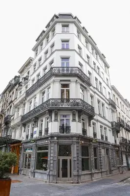 a white building with balconies on the side of it at The Mila Hotel in Brussels