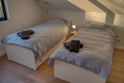 a bedroom with two twin beds in a attic at Vakantiewoning DRP29 in Zelem