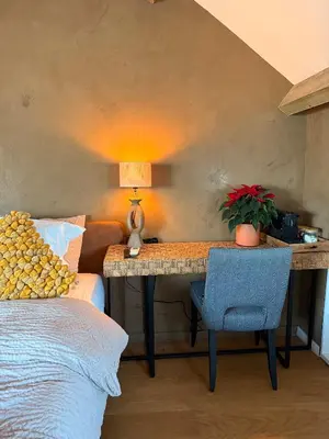 a bedroom with a desk with a lamp and a chair at BeMe in Waterloo