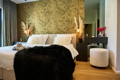 a bedroom with a bed with a cat laying on it at BeMe in Waterloo
