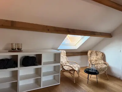 a room with white shelves and two chairs and a skylight at BeMe in Waterloo