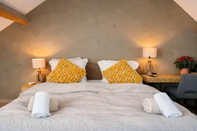 a bedroom with two beds with yellow pillows at BeMe in Waterloo