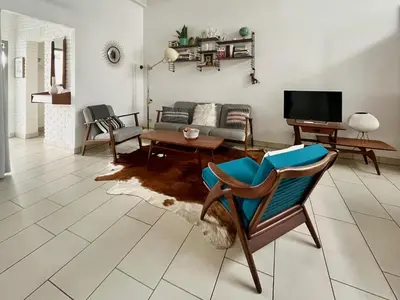 a living room with a couch and a chair at Lounge in the Intimate Urban Garden at a Retro Getaway in Ghent