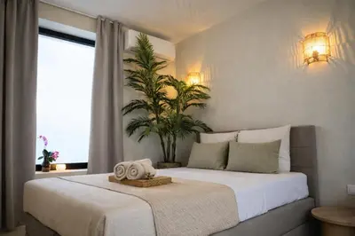a bedroom with a bed with two towels on it at KYOTO SUITES - Antwerp in Antwerp