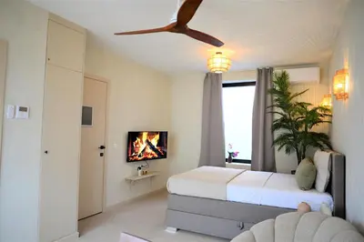 a bedroom with a bed and a ceiling fan at KYOTO SUITES - Antwerp in Antwerp