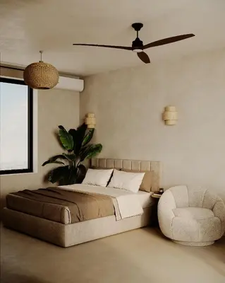 a bedroom with a bed and a fan and a chair at KYOTO SUITES - Antwerp in Antwerp