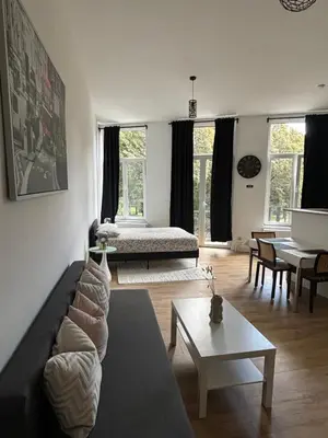 a living room with a couch and a table at Studio Nour in Brussels