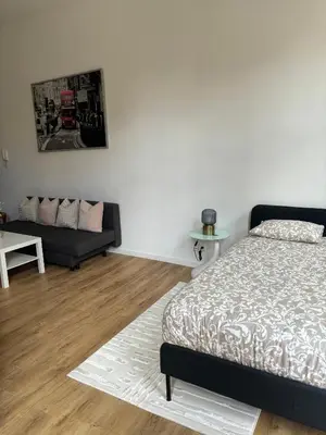 a living room with a bed and a couch at Studio Nour in Brussels