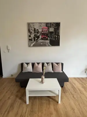 a living room with a couch and a red double decker bus at Studio Nour in Brussels