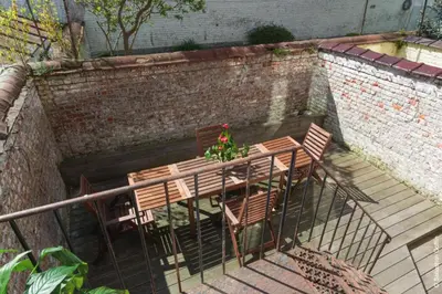 a wooden table and chairs with a plant on it at Flagey Terrace Design residence in Brussels