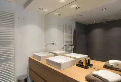 a bathroom with two white sinks and a mirror at Flagey Terrace Design residence in Brussels