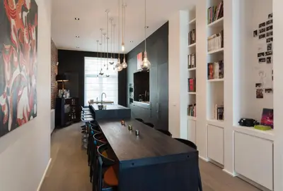 a large dining room with a long table and chairs at Flagey Terrace Design residence in Brussels