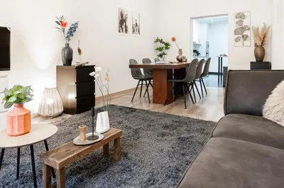 a living room with a couch and a table at Unique Parking access, XL home w Parking option in Antwerp