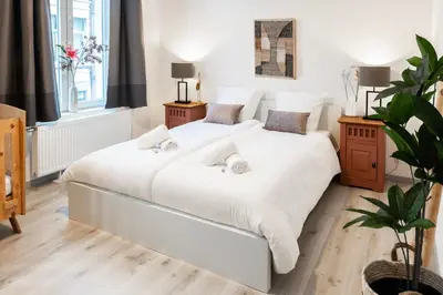 a bedroom with two beds with white sheets at Unique Parking access, XL home w Parking option in Antwerp