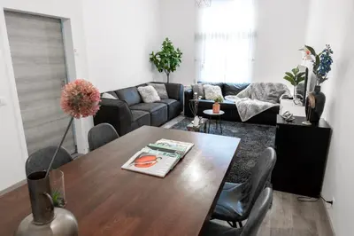 a living room with a table and a couch at Unique Parking access, XL home w Parking option in Antwerp