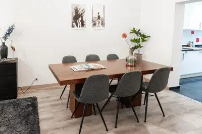 a dining room table and chairs in a room at Unique Parking access, XL home w Parking option in Antwerp