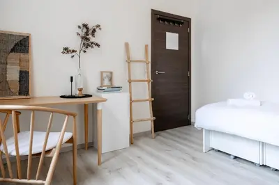 a bedroom with a desk and a bed and a ladder at Unique Parking access, XL home w Parking option in Antwerp