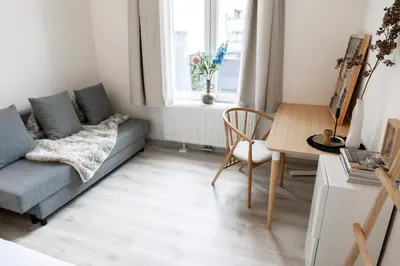 a living room with a couch and a table at Unique Parking access, XL home w Parking option in Antwerp