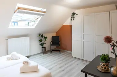 a bedroom with a bed and a desk and a skylight at Unique Parking access, XL home w Parking option in Antwerp