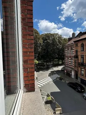 a brick building with a view of a city street at Studio Issa in Brussels