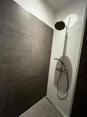 a bathroom with a shower with a shower head at Beautiful apartment Antwerp in Antwerp