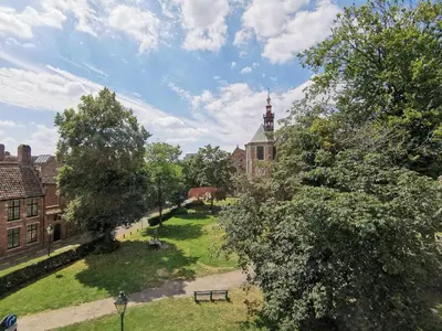 a view of a campus with a building and trees at Private room near Gravensteen in Ghent