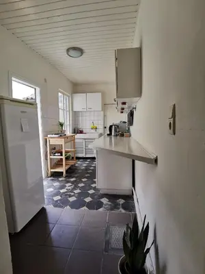 a kitchen with a refrigerator and a counter in it at Private room near Gravensteen in Ghent
