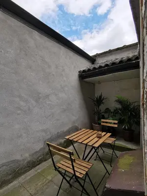 a picnic table and two chairs on a patio at Private room near Gravensteen in Ghent