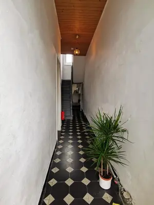 a hallway with a black and white checkered floor at Private room near Gravensteen in Ghent