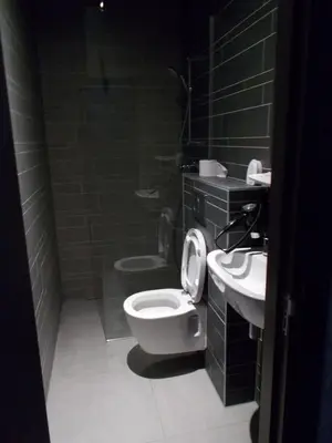 a bathroom with a toilet and a sink at Urban City Centre Hostel in Brussels