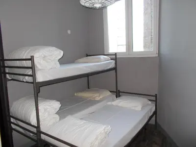 three bunk beds in a room with a window at Urban City Centre Hostel in Brussels