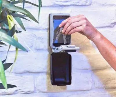 a hand holding a cell phone in a cell phone holder at Skyway airport apartments in Zaventem