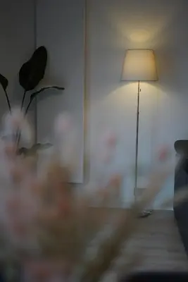 a living room with a lamp and a plant at Skyway airport apartments in Zaventem