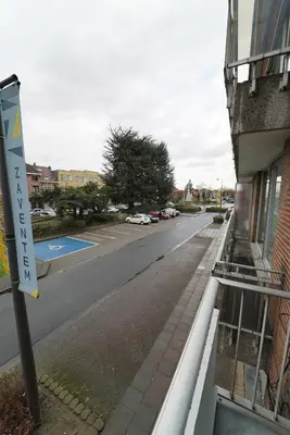 an empty street with a sign on the side of a building at Skyway airport apartments in Zaventem