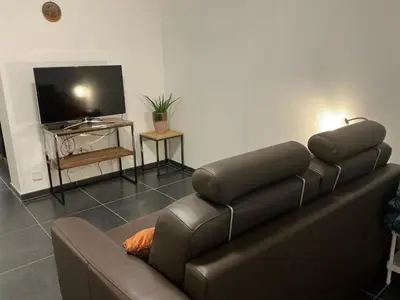a living room with a couch and a flat screen tv at Aura Diest in Diest