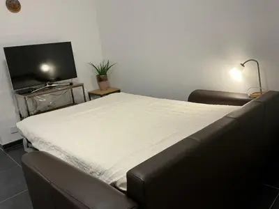 a room with a bed and a flat screen tv at Aura Diest in Diest