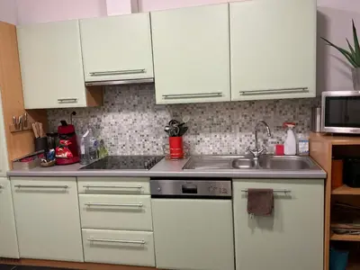 a kitchen with white cabinets and a sink at Aura Diest in Diest