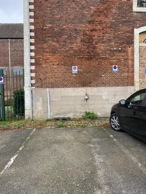 a black car parked in front of a brick building at Aura Diest in Diest