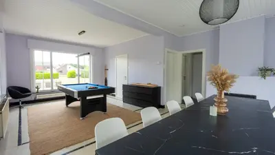 a dining room with a table and a pool table at Nethehuis in Kasterlee
