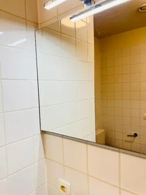 a bathroom with a mirror and white tiled walls at visit Brussels city in Brussels