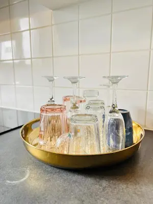 a gold tray with four glass containers on a counter at visit Brussels city in Brussels