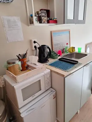 a kitchen with a microwave and a laptop on a counter at Cozy house in Ghent