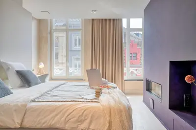 a bedroom with a bed with a laptop on it at Garden View Apt in Ghent in Ghent