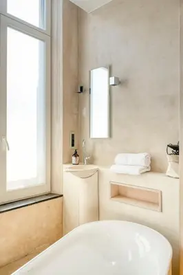 a bathroom with a tub and a sink and a mirror at Garden View Apt in Ghent in Ghent