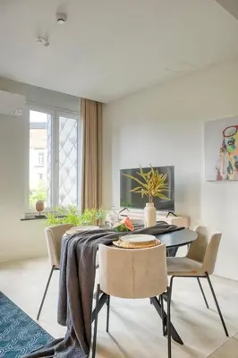 a dining room with a table and chairs at Garden View Apt in Ghent in Ghent
