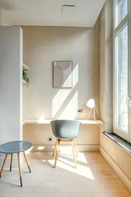 a chair and a table in a room with a window at Garden View Apt in Ghent in Ghent