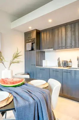 a kitchen with a table with a watermelon on it at Garden View Apt in Ghent in Ghent